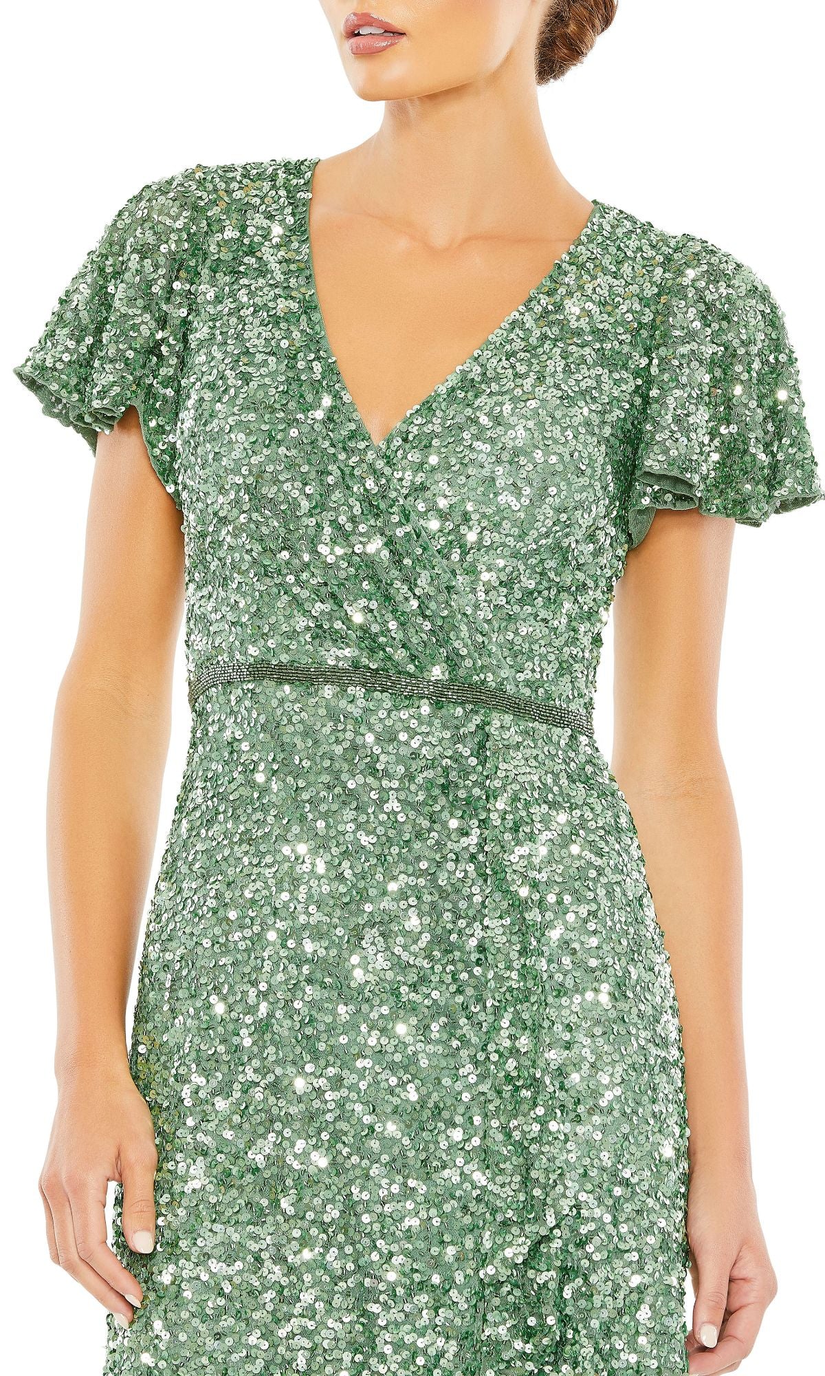 A woman wears the Mac Duggal 5540 Short-Sleeve Sequin Formal Dress in green, featuring a V-neck and fitted waist. Her face is partially out of frame.